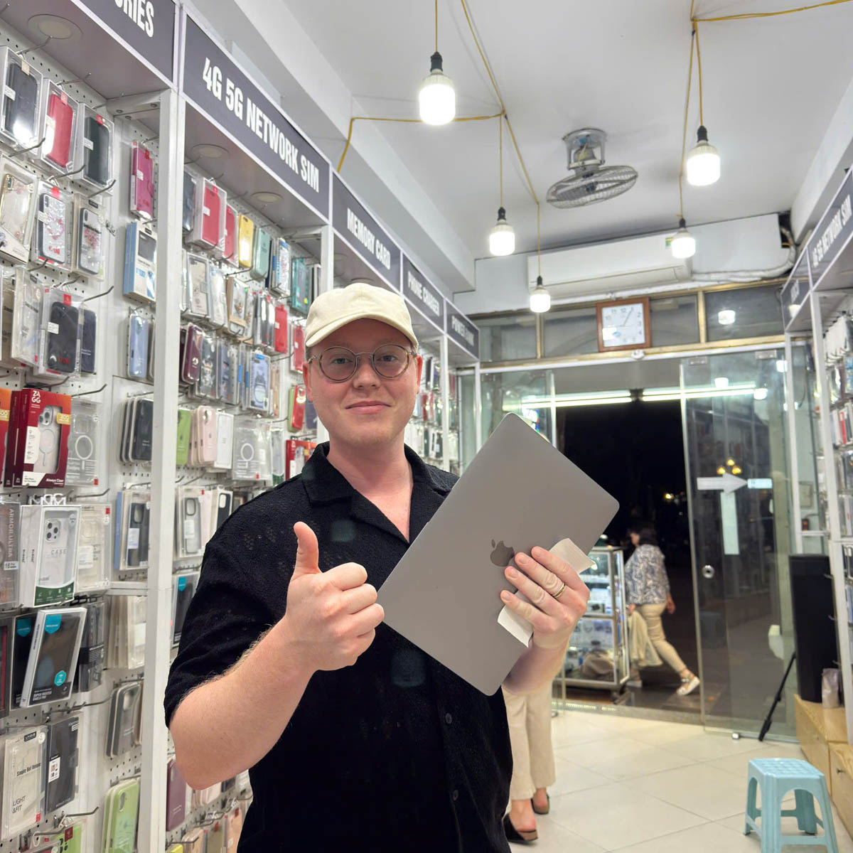 Customer holding a repaired device after in-store service