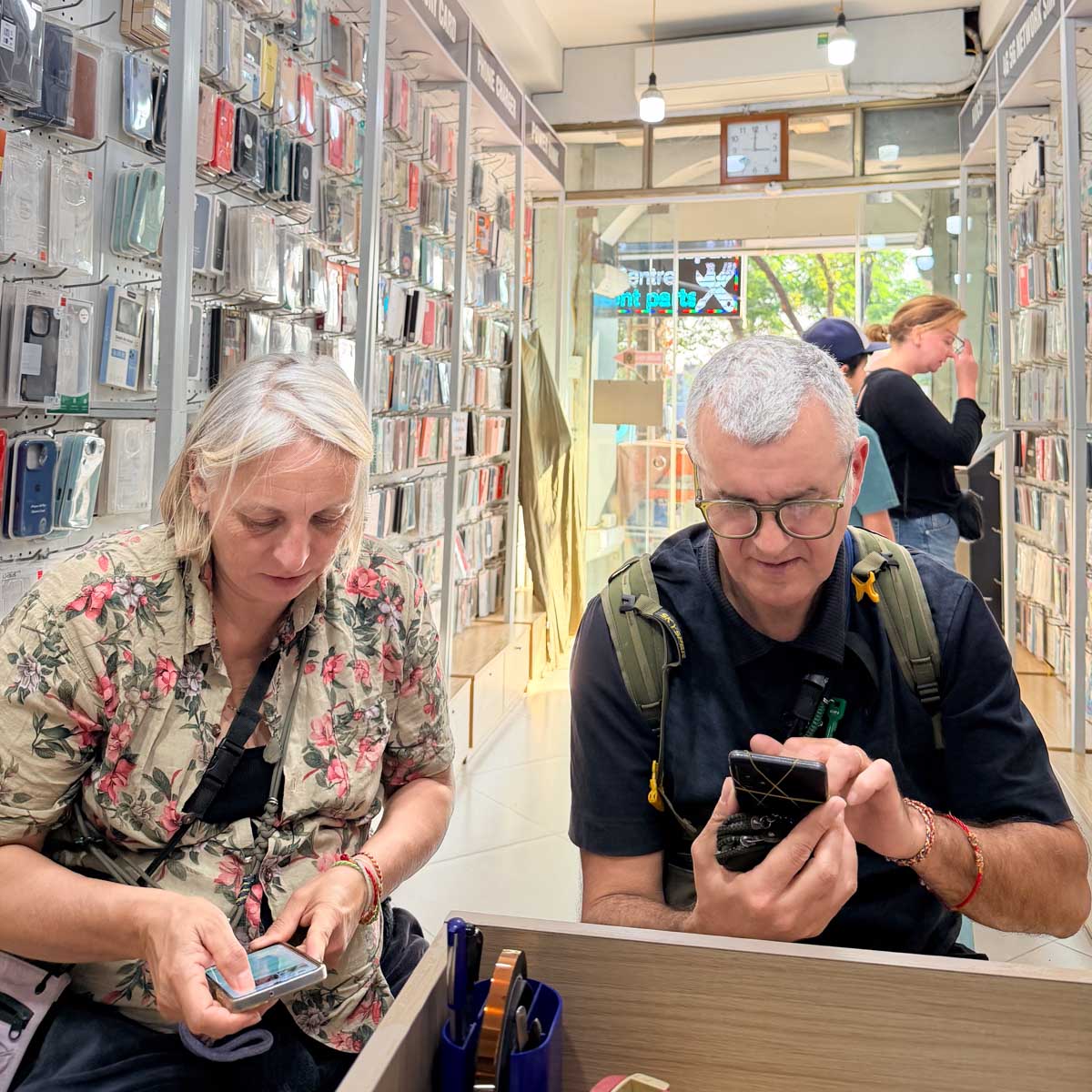 Group of international customers receiving device consultation inside the store