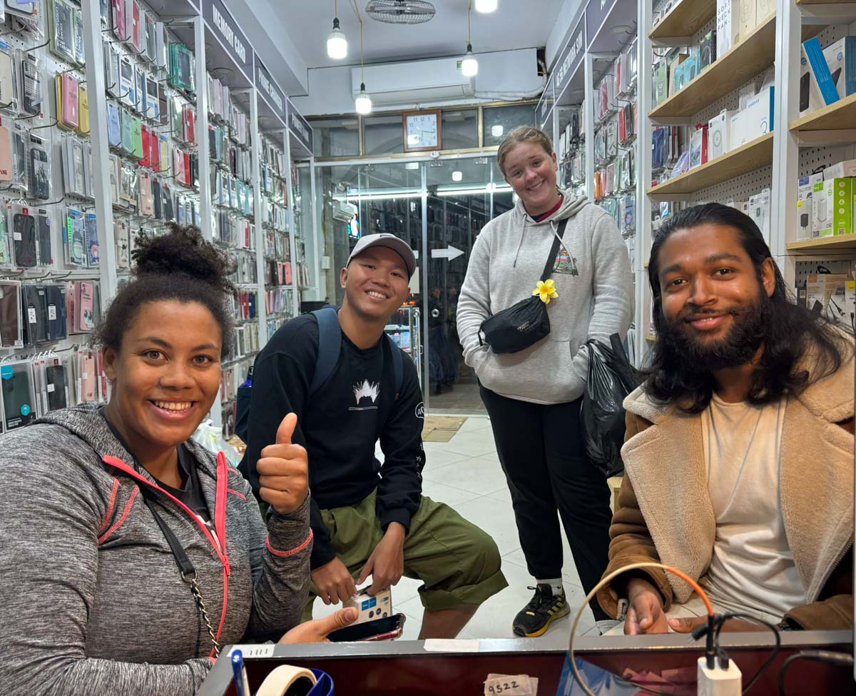 Group of international customers inside the store during device support and accessory assistance