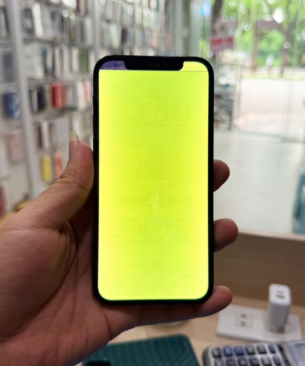 iPhone 12 Pro display showing severe screen discoloration before screen replacement