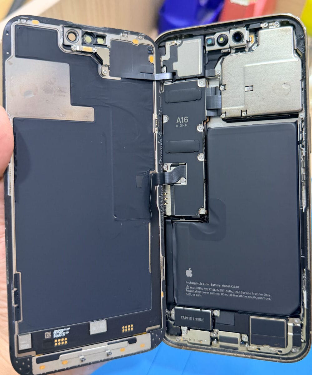 Opened iPhone 14 Pro Max showing internal components during water damage inspection
